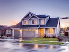 Elegant suburban home with driveway at sunset showcasing modern architecture.
