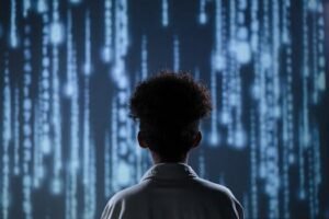 pexels-photo-9783353-9783353 - Telugu Word A young boy viewing a digital screen with data streams, symbolizing technology interaction.